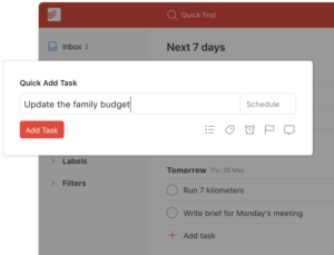 Todoist quick add task feature displaying a task entry for updating the family budget.
